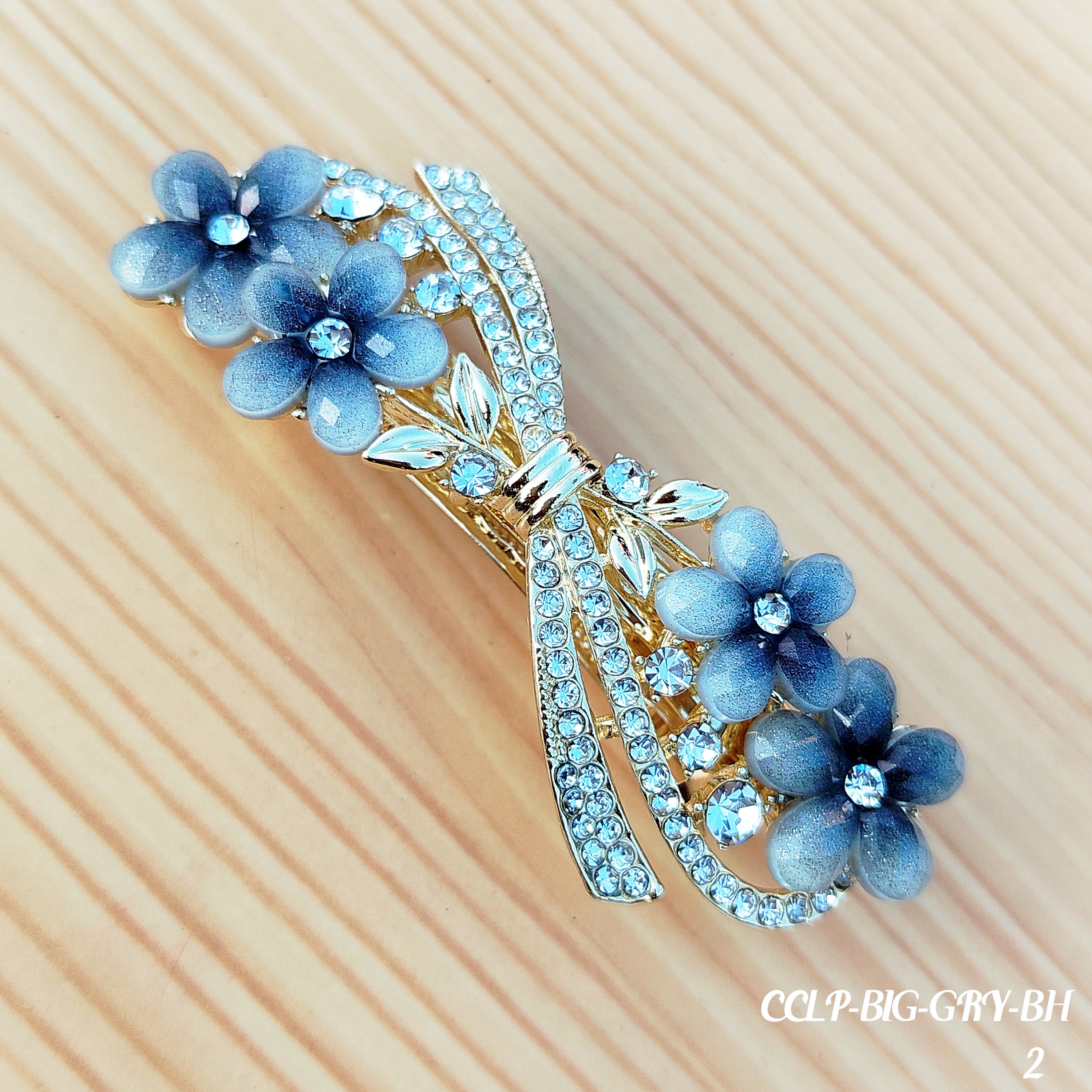Elegant floral bow hair clips featuring sparkling crystal stones and a glossy enamel finish