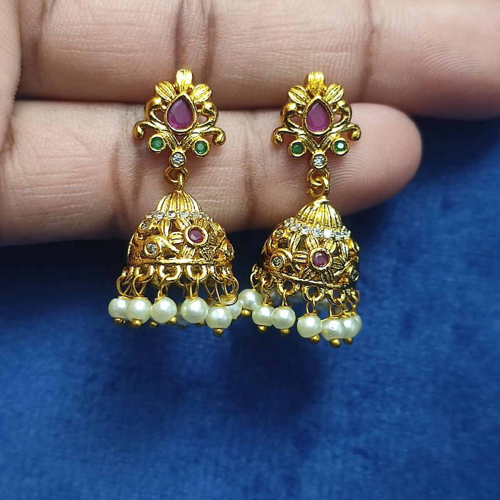 Radiant gold-toned jhumkas with pearl drops