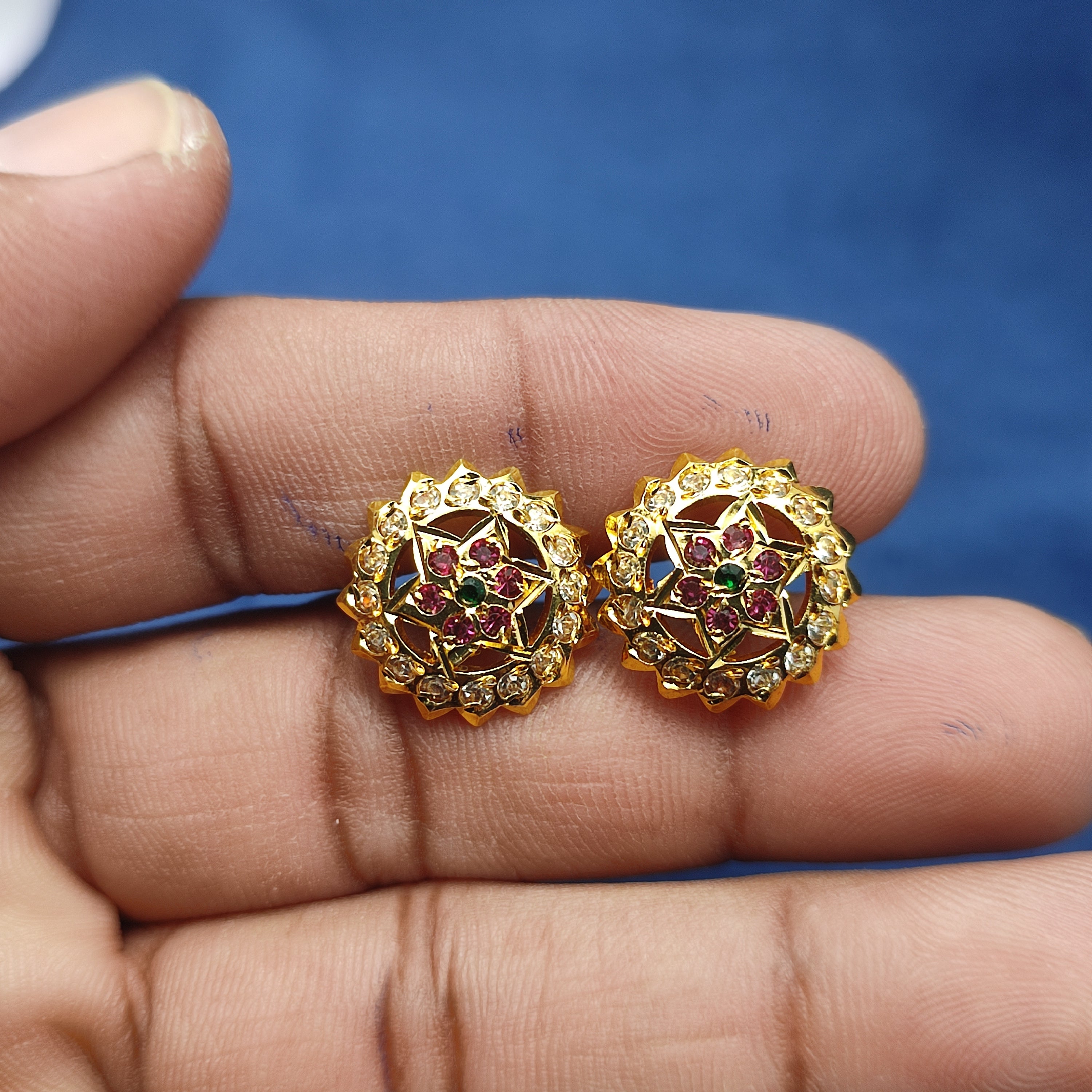 Elegant floral stud earrings  sparkling white stones and rich ruby-red stone and green stone.