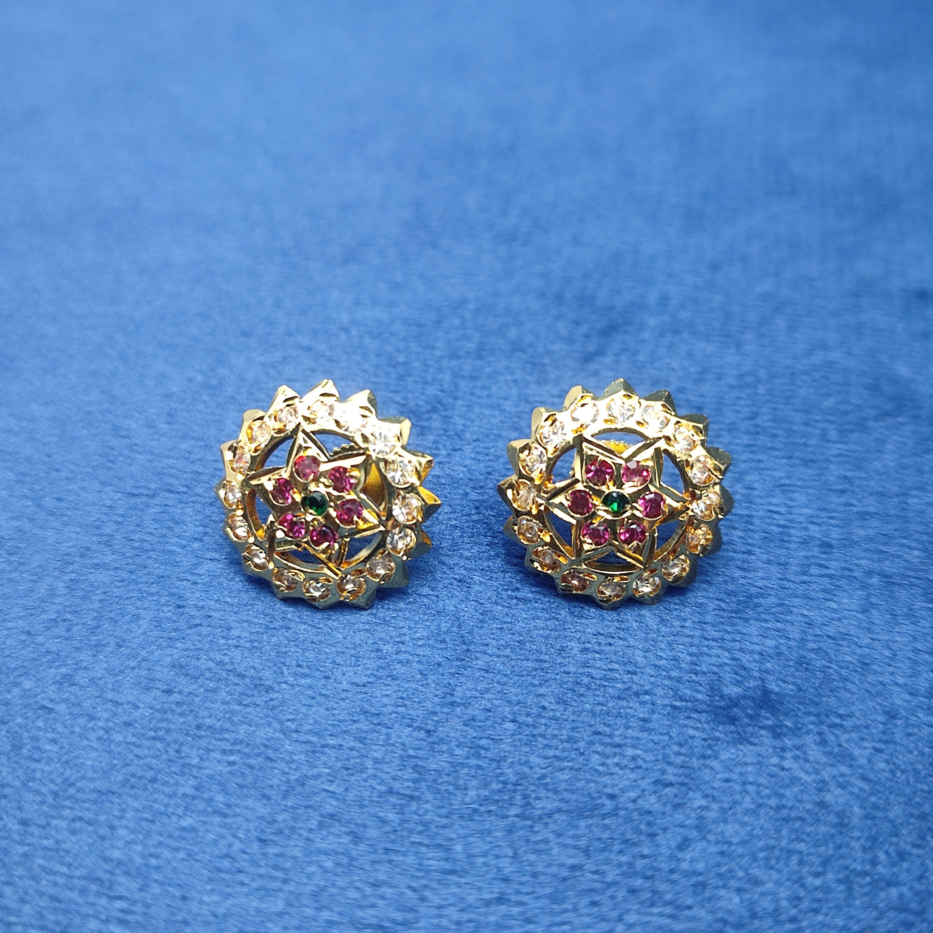 Elegant floral stud earrings  sparkling white stones and rich ruby-red stone and green stone.