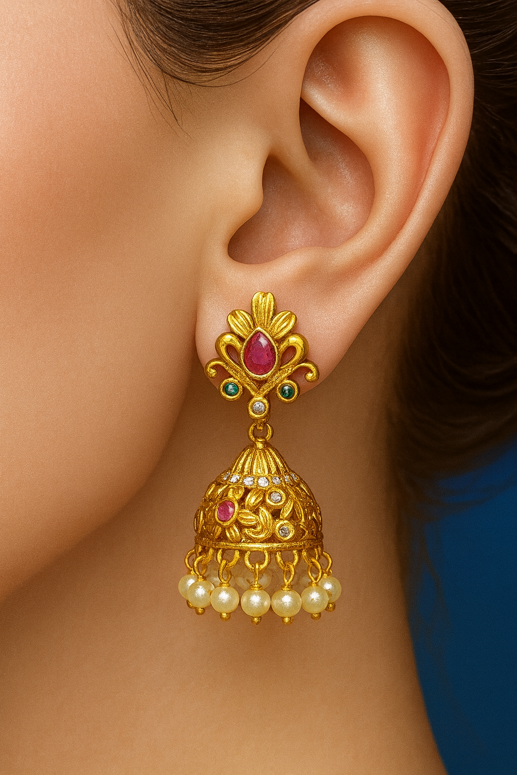 Radiant gold-toned jhumkas with pearl drops