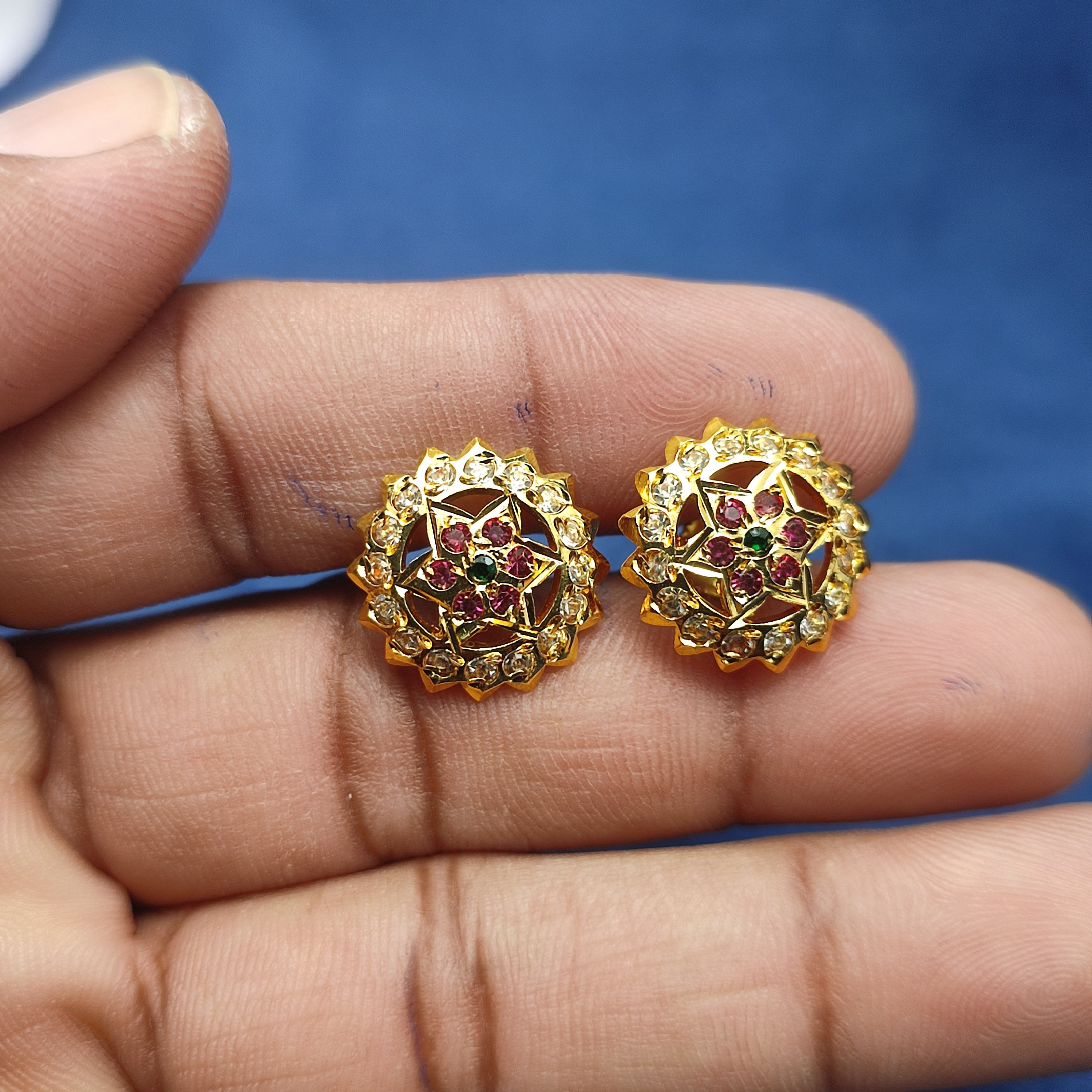 Elegant floral stud earrings  sparkling white stones and rich ruby-red stone and green stone.